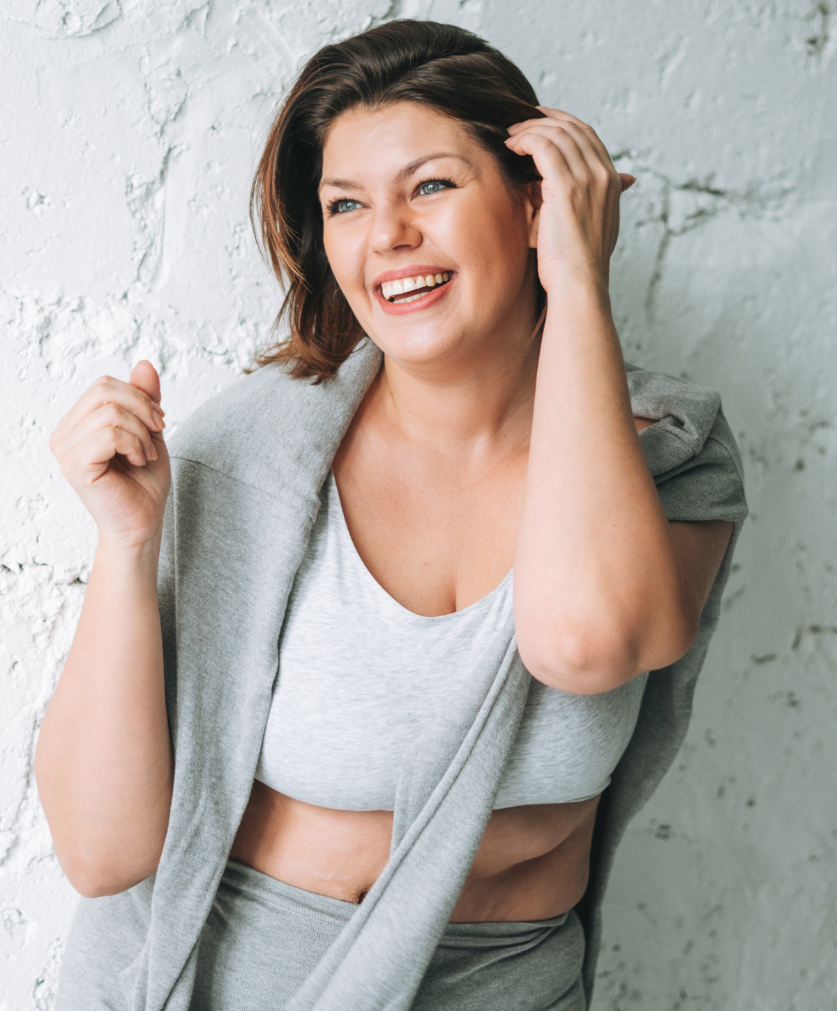 Sacramento body sculpting model wearing a red top